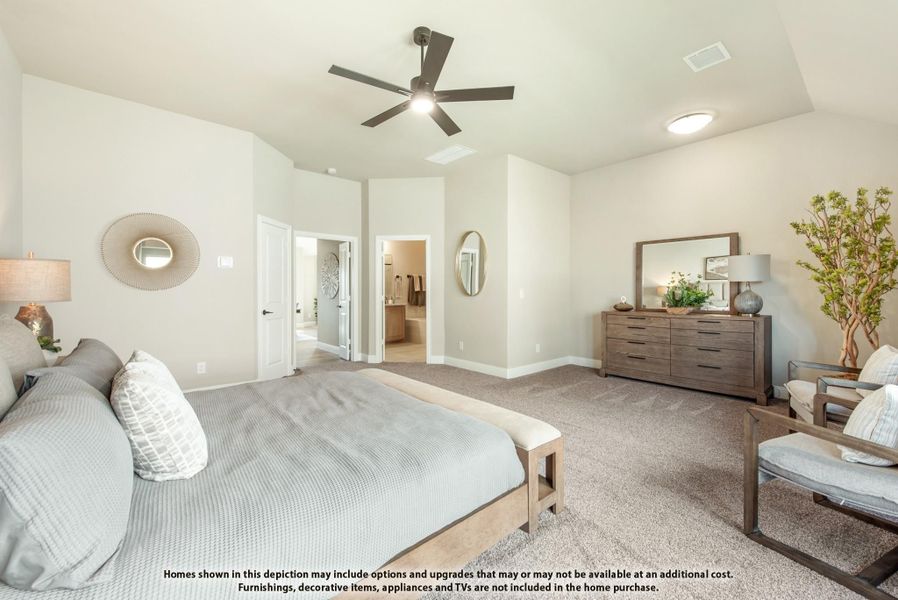 Master bedroom with vaulted ceiling, ceiling fan, carpet flooring, and ensuite bathroom access