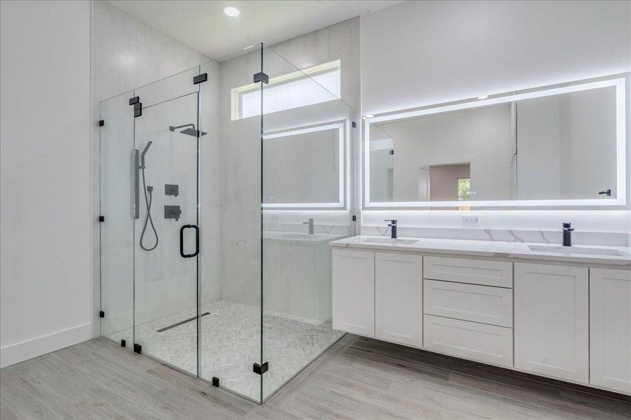Bathroom featuring wood finished floors, and double vanity Bathroom featuring wood finished floors, and double vanity