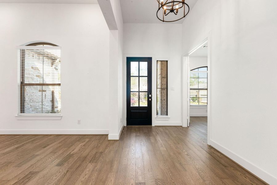 Upon entering you are greeted with a dedicated office in the front, beautiful, engineered wood flooring, formal dining area with tons of natural light.