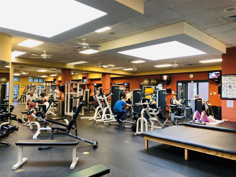 Fitness center with ample equipment for diverse workout routines, ensuring an active lifestyle. Fitness center with ample equipment for diverse workout routines, ensuring an active lifestyle.