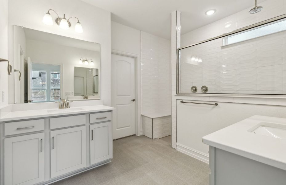 Elegant owner's bathroom with dual vanity *real home pictured