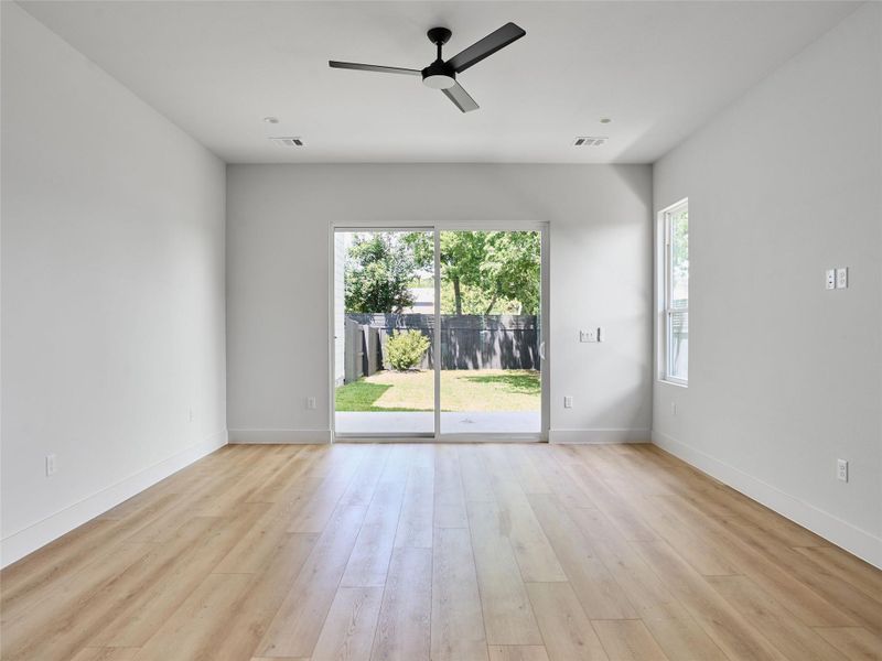 Empty room with ceiling fan and light wood-type flooring Empty room with ceiling fan and light wood-type flooring