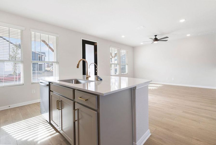 Kitchen with light wood-style flooring, open floor plan, a center island with sink, stainless steel dishwasher, and recessed lighting
