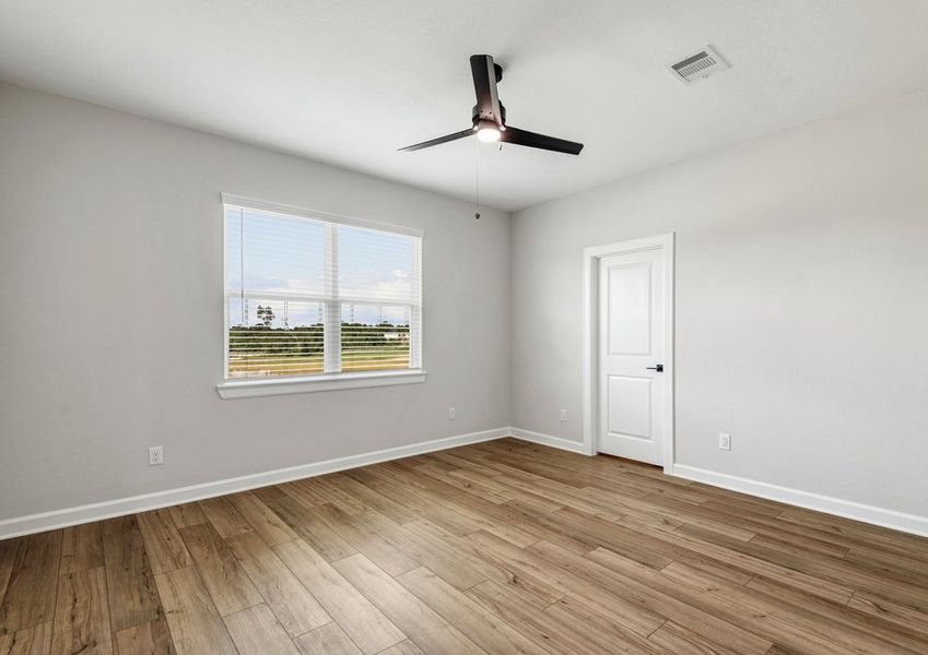 The master bedroom has a large window that provides natural light