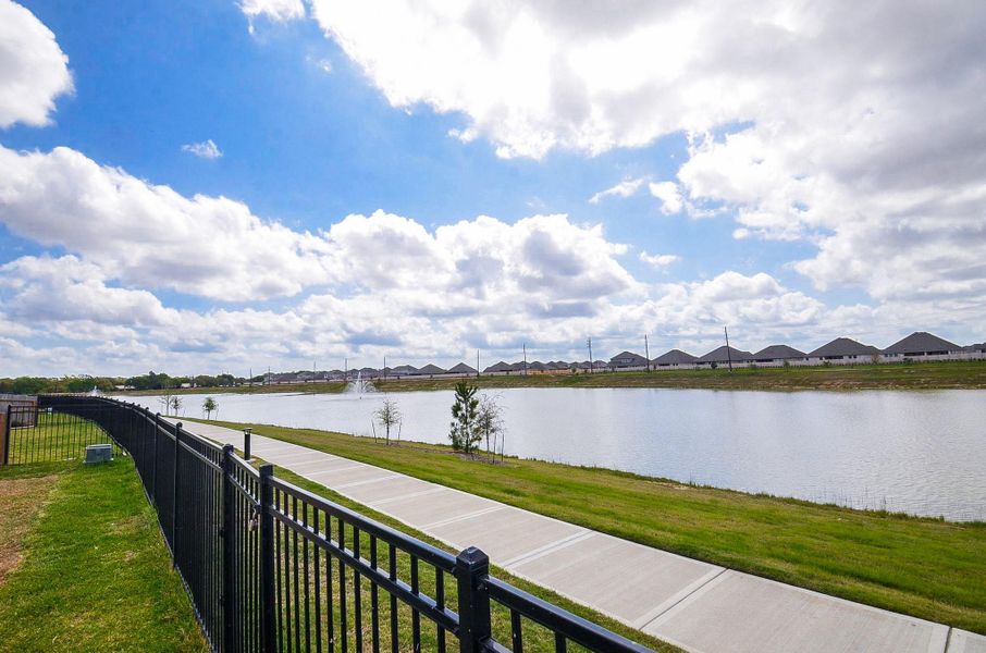 This photo showcases a serene water view with a walking pathway making it ideal for leisurely strolls and enjoying the outdoors.