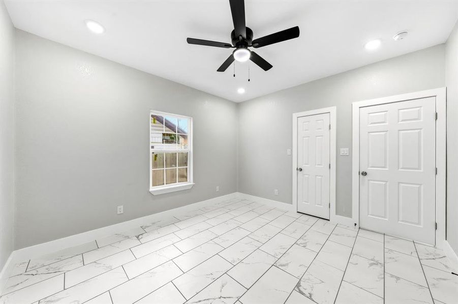 Spare room featuring light marble finish floors, ceiling fan, and recessed lighting
