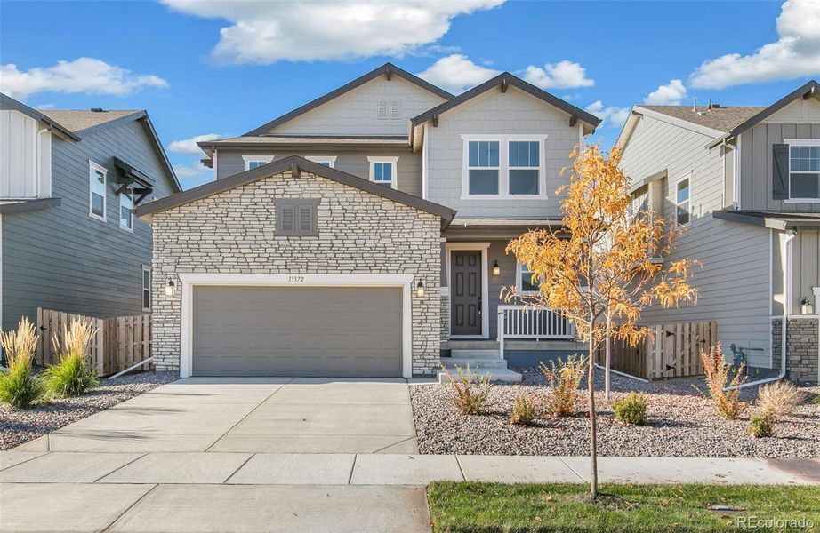 Front exterior of a new home in Turnberry, Commerce City, CO, highlighting curb appeal (Image 2). Front exterior of a new home in Turnberry, Commerce City, CO, highlighting curb appeal (Image 2).