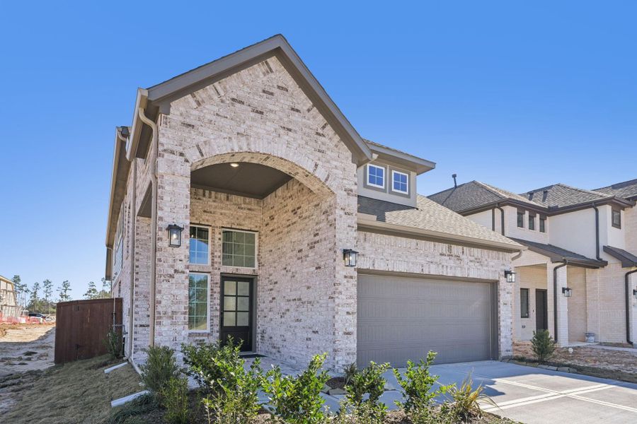 Front exterior of a new home in Evergreen, Conroe, TX, highlighting curb appeal (Image 16).