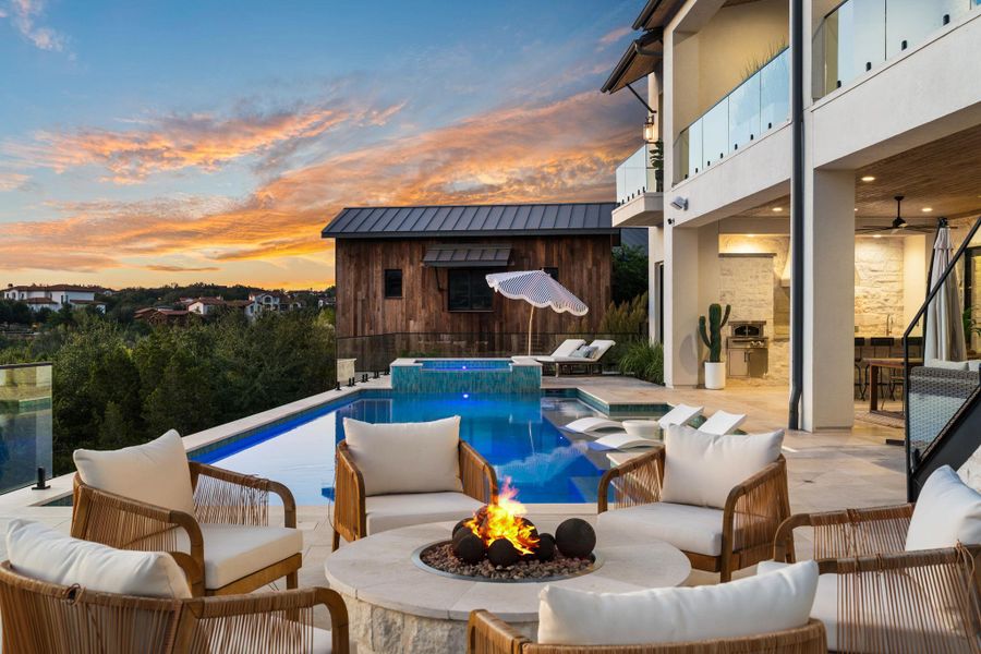 View of swimming pool featuring a balcony, a patio, an outdoor living space with a fire pit, an outdoor structure, and a pool with connected hot tub View of swimming pool featuring a balcony, a patio, an outdoor living space with a fire pit, an outdoor structure, and a pool with connected hot tub