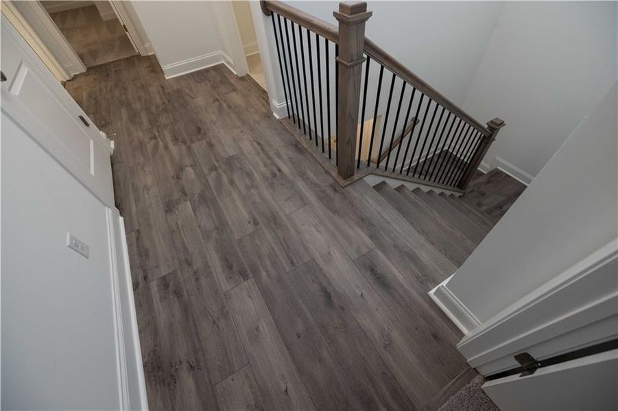 Oak treads on stairs, hard surface flooring in upstairs hallway. Pictures represent a previously built home not the actual home, home is under construction.