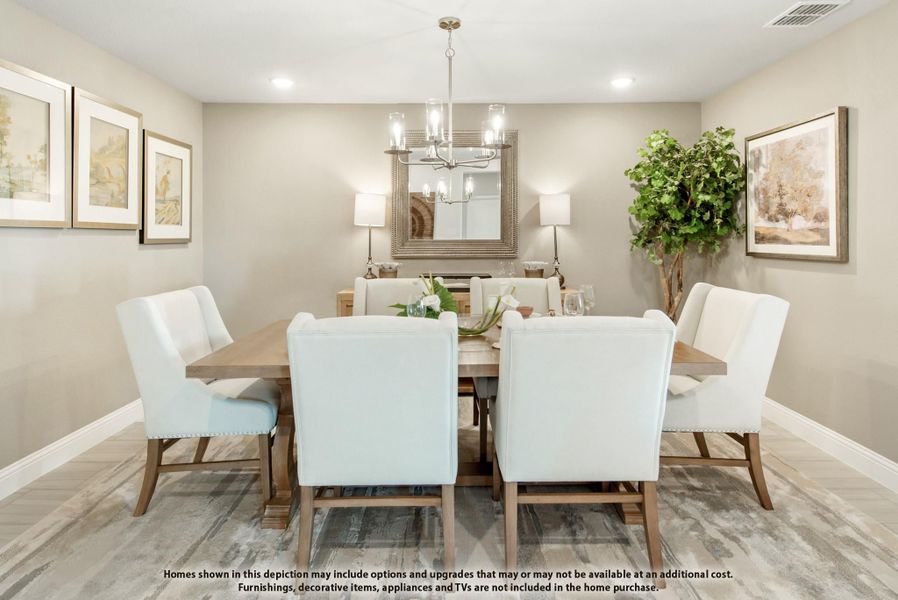 Dining room with wood table, white upholstered chairs, chandelier, and large mirror on neutral walls