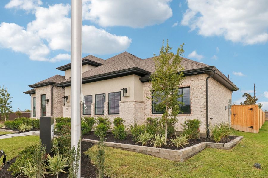 Front exterior of a new home in The Woodlands Hills, Willis, TX, highlighting curb appeal (Image 21).