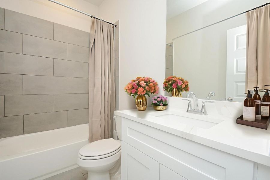 Step into this lovely bathroom that has a gorgeous tile wall in the tub/shower combination.