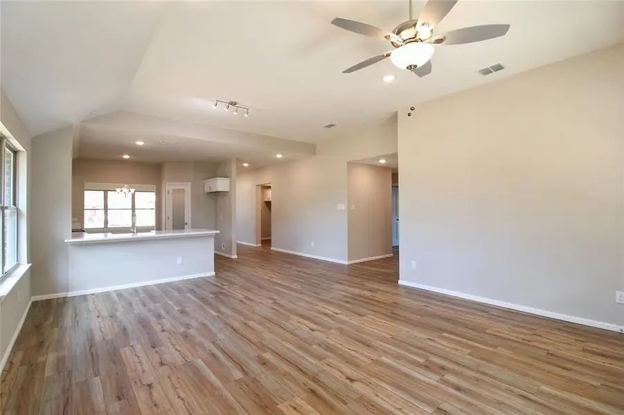 Unfurnished room with recessed lighting, light wood-style floors, a chandelier, and a ceiling fan