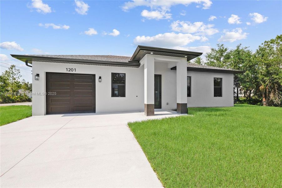 Front exterior of a new home in , Lehigh Acres, FL, highlighting curb appeal (Image 16).