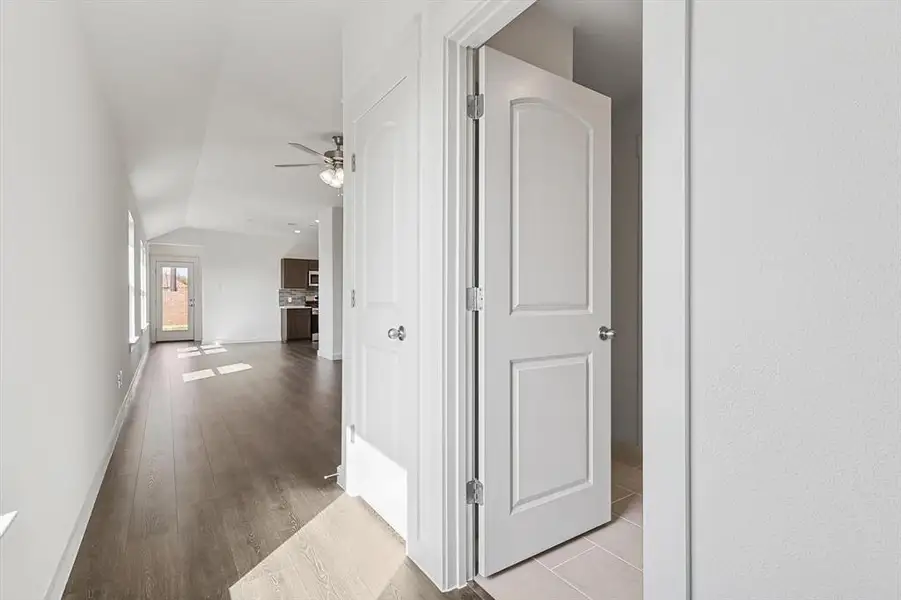 Hall with lofted ceiling and light wood-type flooring Hall with lofted ceiling and light wood-type flooring