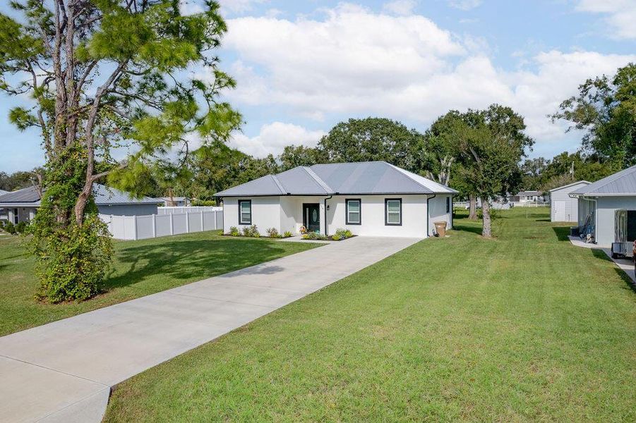 Front exterior of a new home in , Okeechobee, FL, highlighting curb appeal (Image 21).