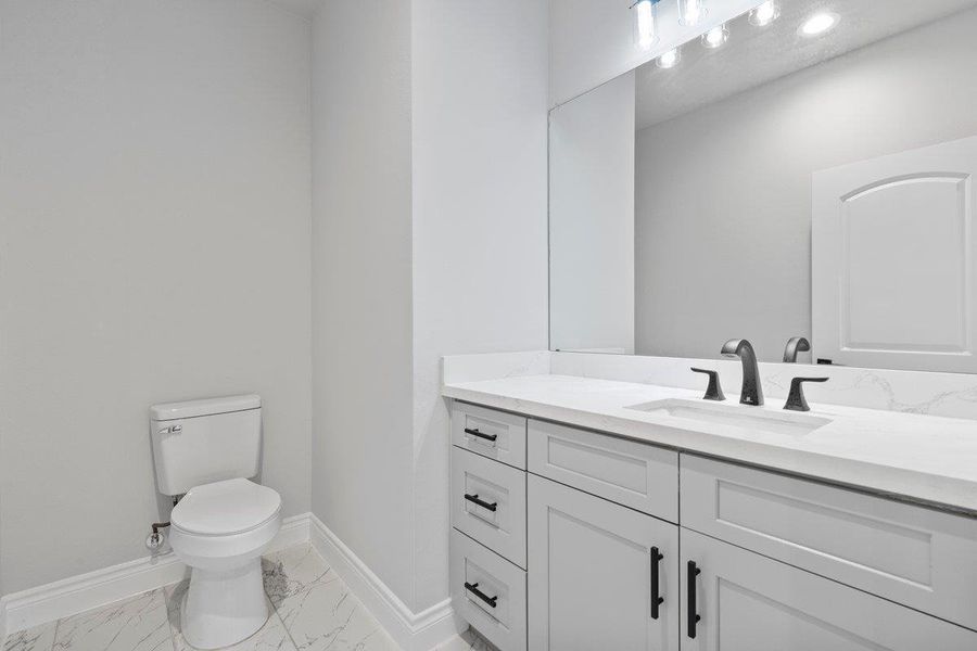 Half bath off of entryway hall.