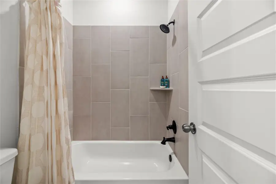 Spotless and fully tiled, this tub/shower combination offers a fresh, functional space that’s perfectly suited for both family and guests.