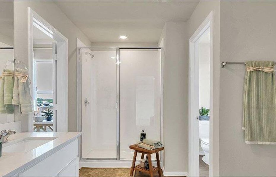 Full bathroom featuring a stall shower, vanity, toilet, and recessed lighting Full bathroom featuring a stall shower, vanity, toilet, and recessed lighting