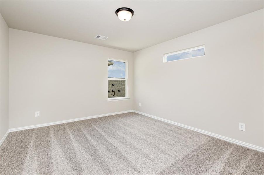 Carpeted empty room with baseboards