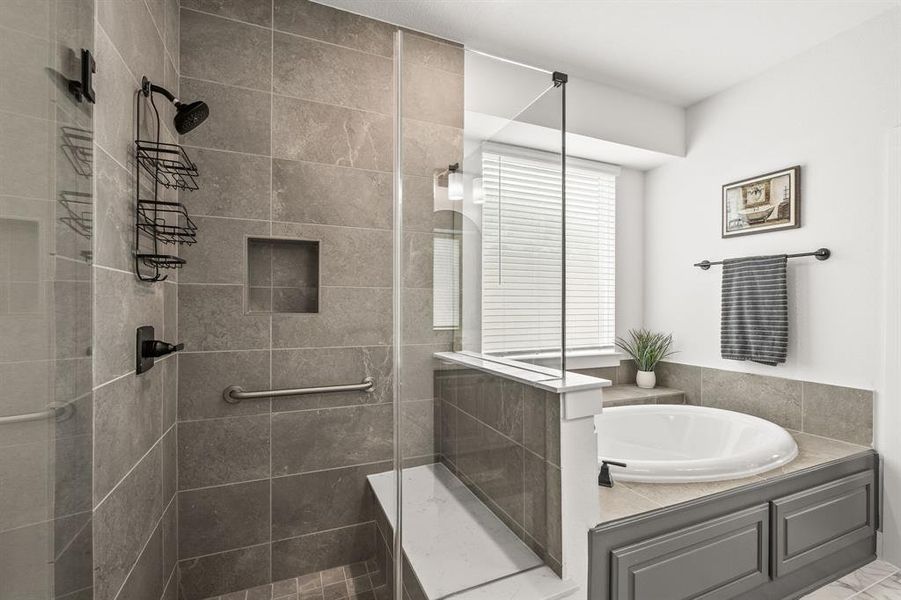 Bathroom featuring a shower stall and a garden tub Bathroom featuring a shower stall and a garden tub