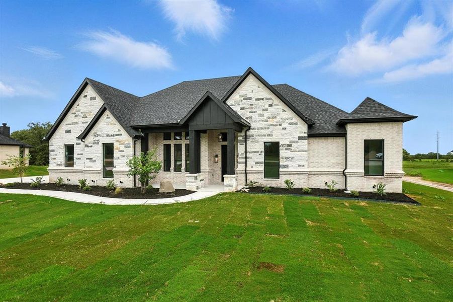 View of front of house featuring a front lawn, brick siding, and a shingled roof View of front of house featuring a front lawn, brick siding, and a shingled roof