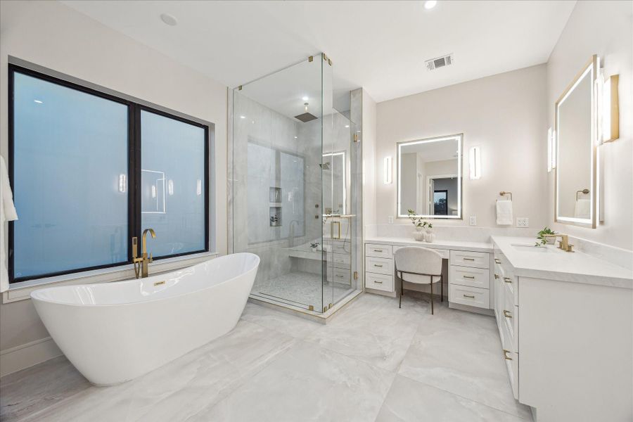 Sleek freestanding tub with gold-tone fixtures enhancing the bath’s serene atmosphere.