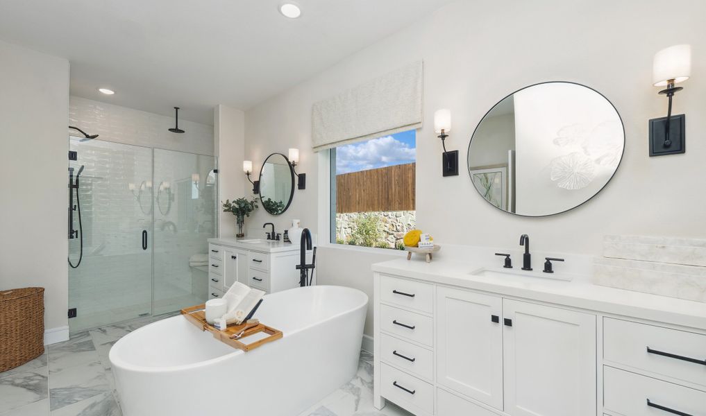 Dual vanities and freestanding tub with matte black fixtures