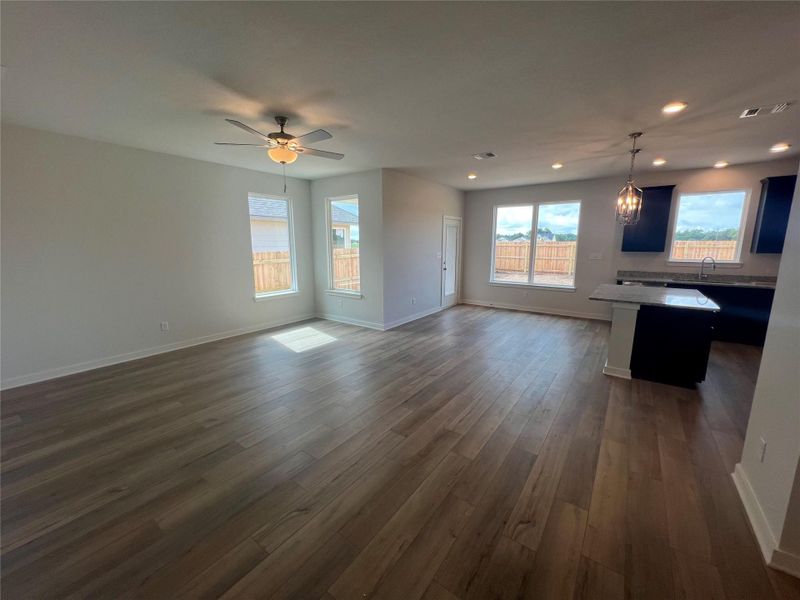 An open-concept layout unites the living area and kitchen, featuring lustrous hardwood flooring and plentiful natural light.