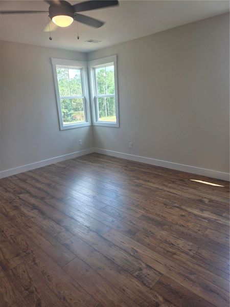 Other side of the primary bedroom with lots of lig Other side of the primary bedroom with lots of lig