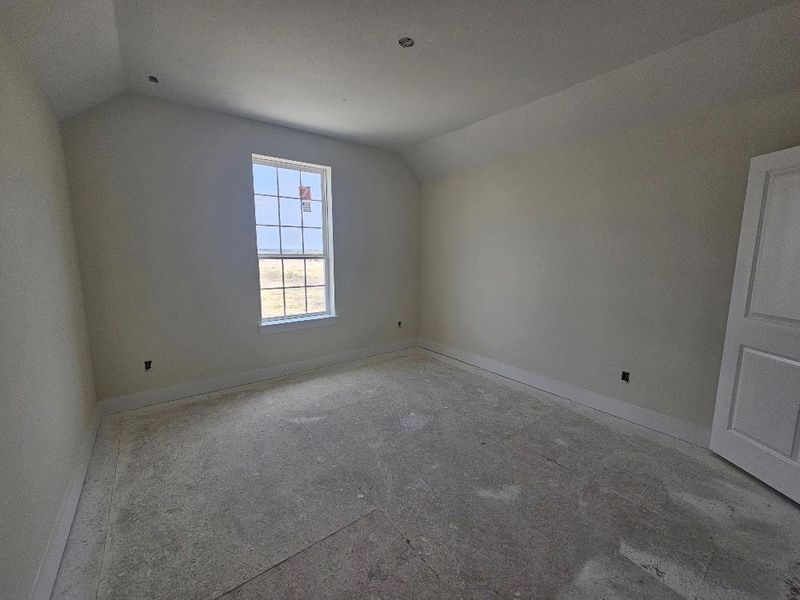 Bonus room with lofted ceiling and baseboards Bonus room with lofted ceiling and baseboards