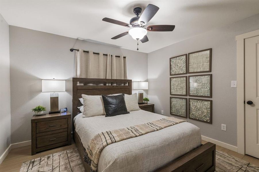 Bedroom with light wood-style flooring and ceiling fan Bedroom with light wood-style flooring and ceiling fan