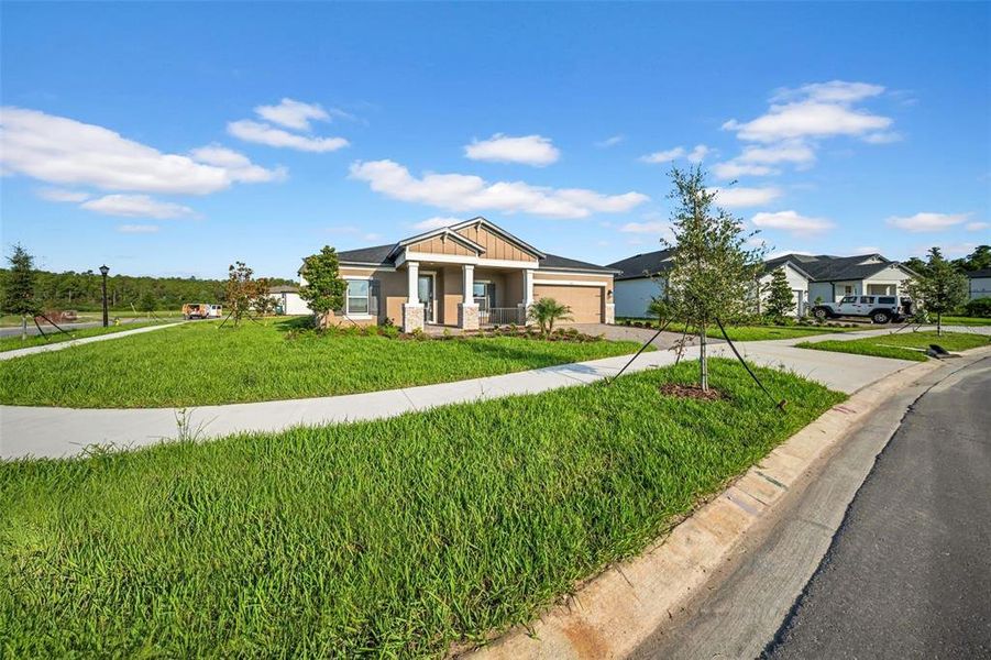 Front exterior of a new home in , Wesley Chapel, FL, highlighting curb appeal (Image 23).
