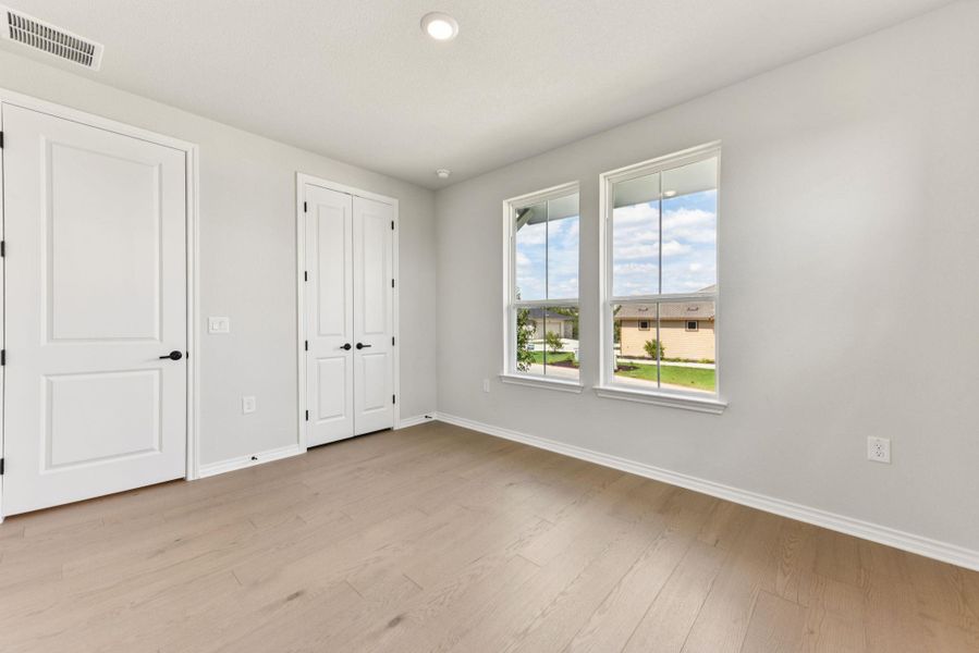 Unfurnished bedroom with light wood-style floors, a closet, and recessed lighting