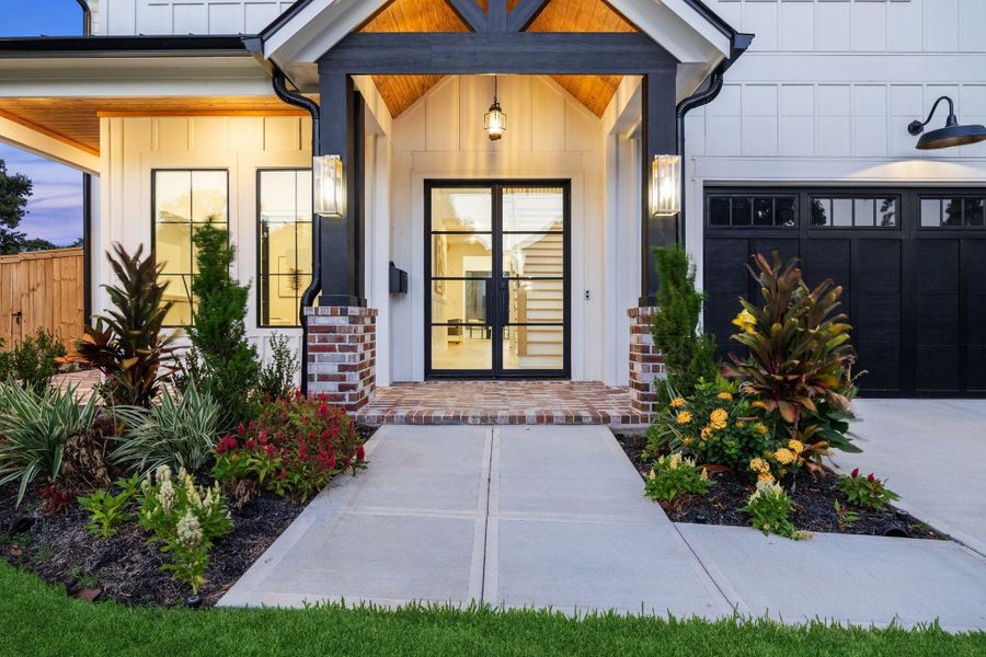 Classic bricked front porch with steel front doors Classic bricked front porch with steel front doors