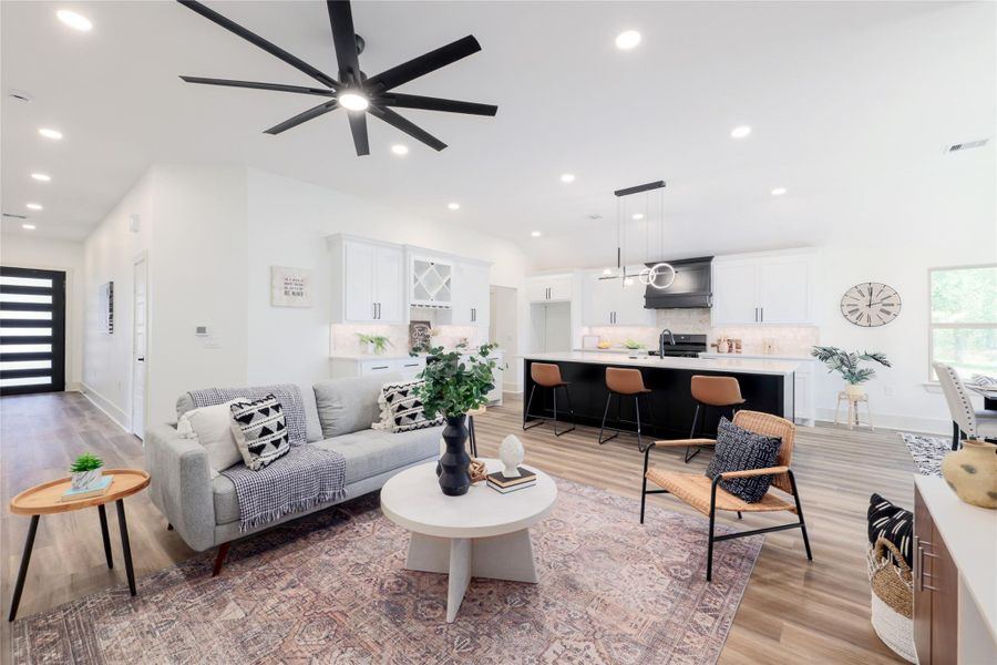 Living room with light wood-style flooring, recessed lighting, and a ceiling fan