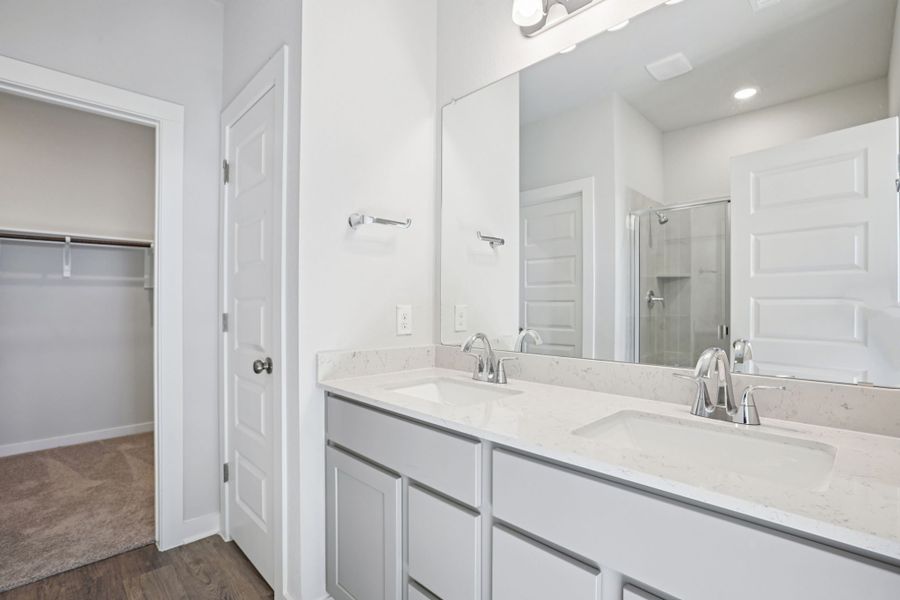 A bathroom with a large mirror.
