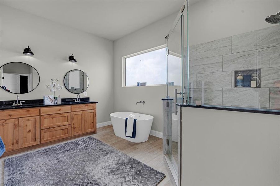 Bathroom featuring vanity, hardwood / wood-style floors, and shower with separate bathtub