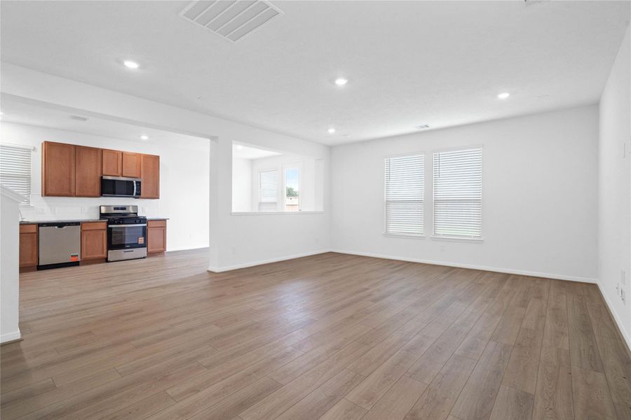Stunning open-concept design seamlessly connecting the living, dining, and kitchen areas—perfect for both everyday living and entertaining!