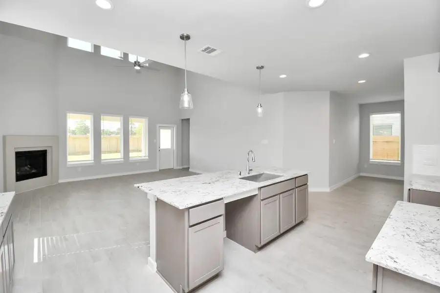 All of this overlooks your expansive family room, creating a perfect space for culinary delights and family gatherings. Sample photo of completed home with similar floor plan. Actual colors and selections may vary.