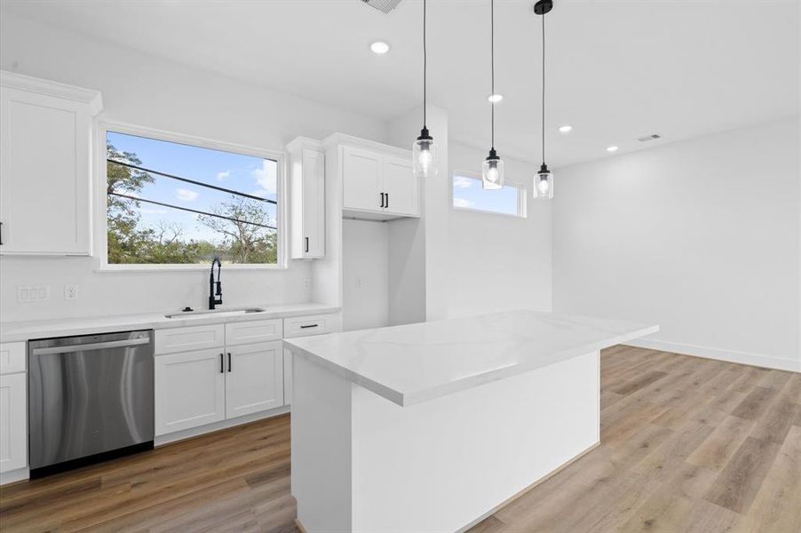 White Cabinets and Countertop with large windows