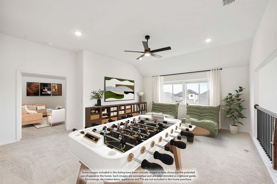 Upstairs game room with foosball table, carpet flooring, ceiling fan, and vaulted ceiling