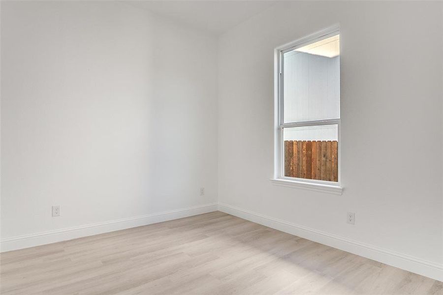 Empty room featuring light wood-style floors and baseboards Empty room featuring light wood-style floors and baseboards