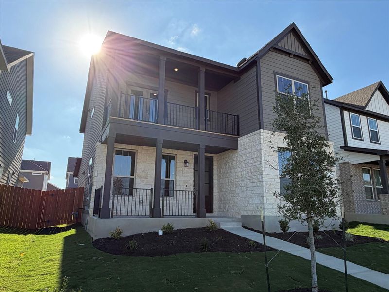 Front exterior of a new home in Lariat, Liberty Hill, TX, highlighting curb appeal (Image 18).