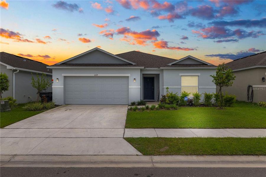 Front exterior of a new home in Ironwood, Lakeland, FL, highlighting curb appeal (Image 20).