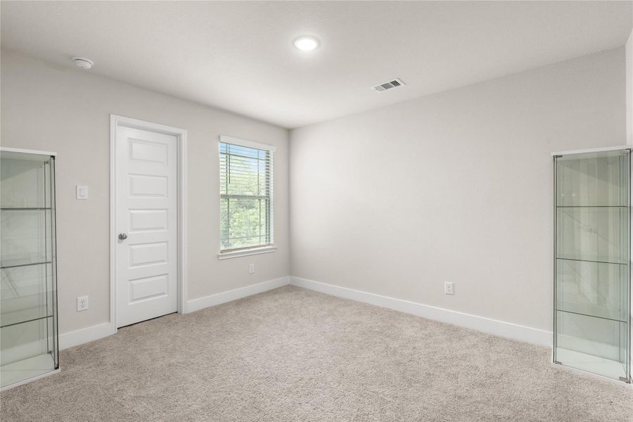 Comfortably proportioned with a large window and walk-in closet, this secondary bedroom is designed to adapt to changing needs over time.