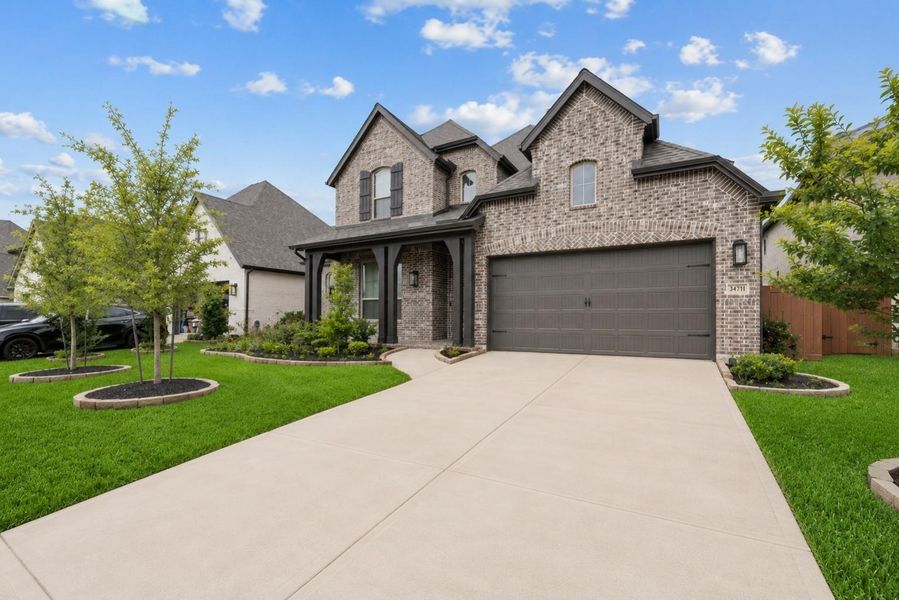Front exterior of a new home in Elyson, Katy, TX, highlighting curb appeal (Image 2). Front exterior of a new home in Elyson, Katy, TX, highlighting curb appeal (Image 2).