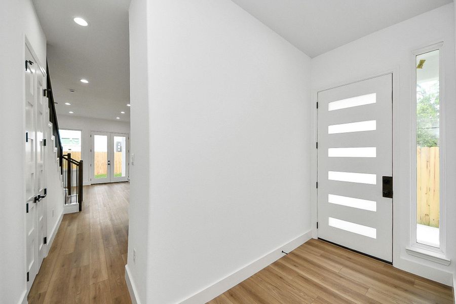 Clean, modern front entry with sleek design and natural light, creating a bright and welcoming first impression.