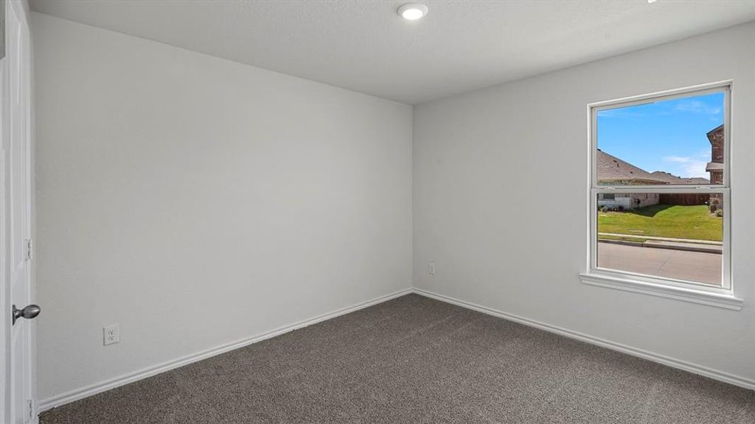 Neutral-toned bedroom featuring a single window, recessed lighting, white baseboards, and neutral carpet flooring